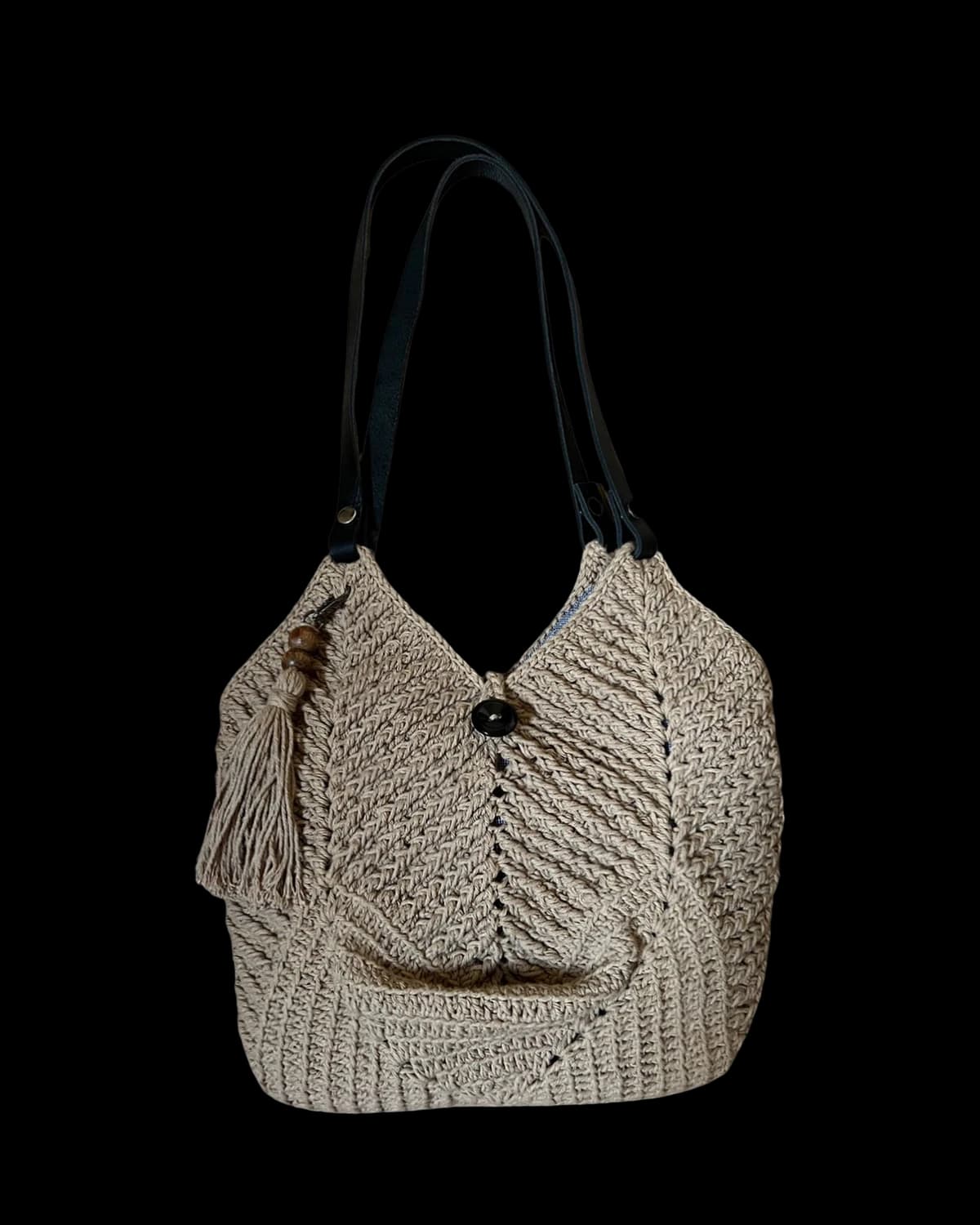 Bolsa Dubai cor areia em crochê de barbante, com tassel e alças tipo couro preto, foto de catálogo em fundo neutro
